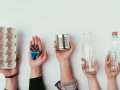 partial view of group of people holding various types of garbage isolated on grey