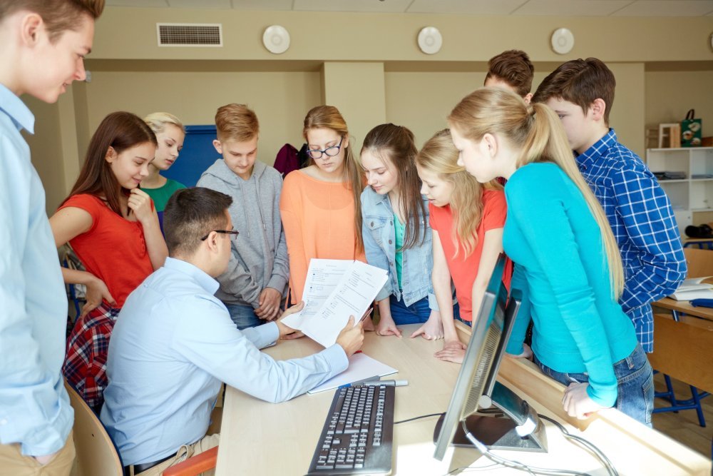 group of students and teacher at school classroom