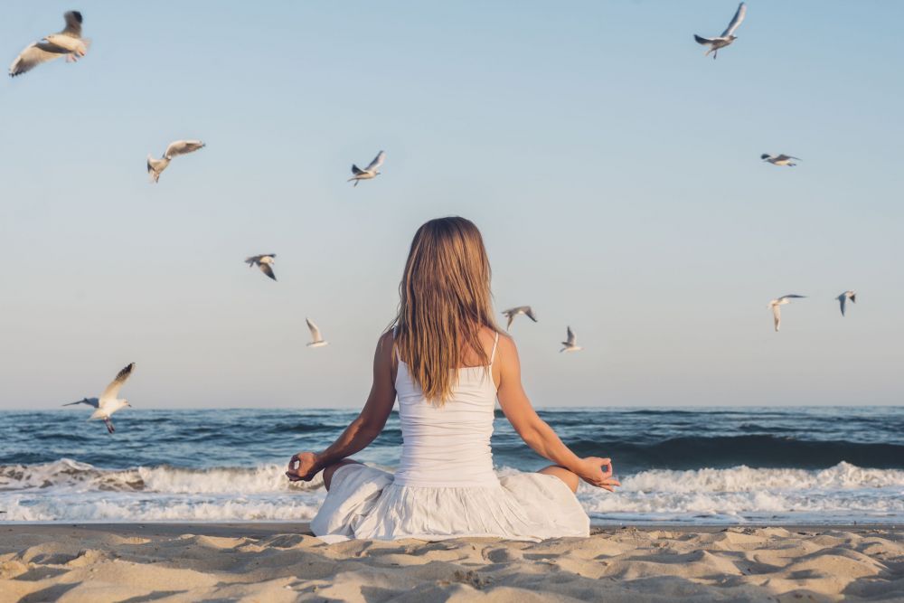 Woman meditating at the sea