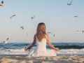 Woman meditating at the sea