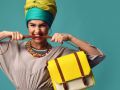 Woman yelling screaming and eating belt of hand hold stylish fashion yellow leather bag