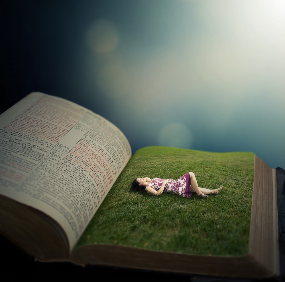 Woman laying on grass field in Bible