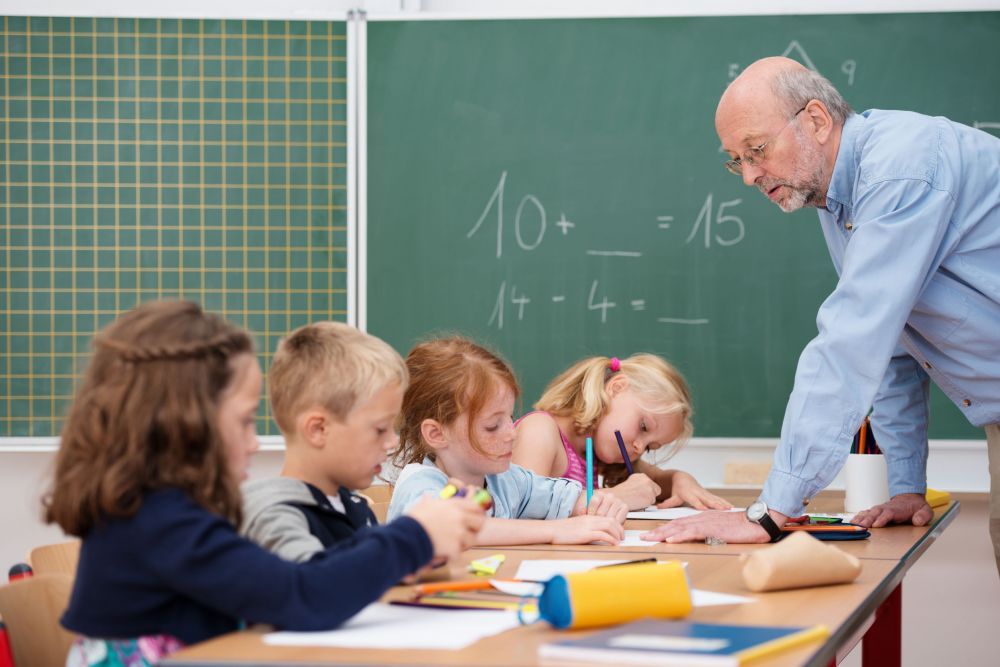 Elderly male teacher in primary school