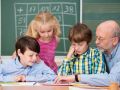 Young schoolchildren in class with their teacher