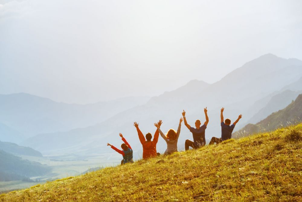 Group happy friends sunset mountains