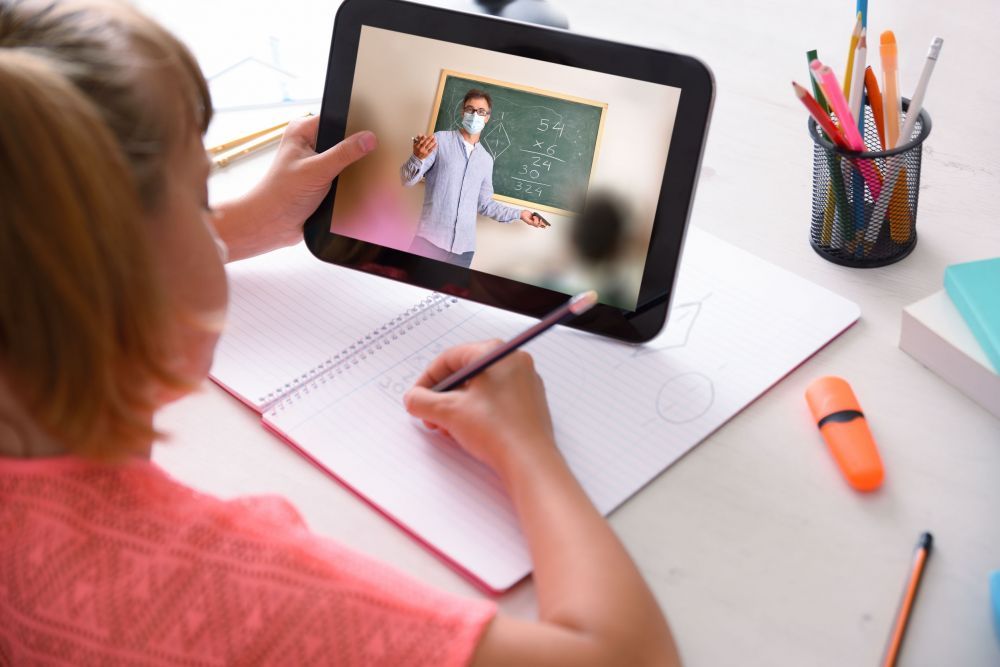 School girl following online school course in quarantine at home