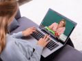 Girl Video Conferencing With Teacher On Laptop