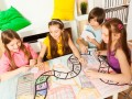 Top view of four kids playing the tabletop game