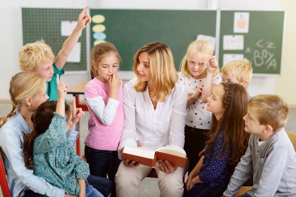 Teacher Teaching Something to her Young Students