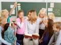 Teacher Teaching Something to her Young Students