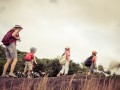 three little kids and mother in the mountains