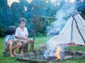 Two sweet children, boy brothers, camping outside summertime on sunset