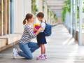 first day at school. mother leads  little child school girl in first grade