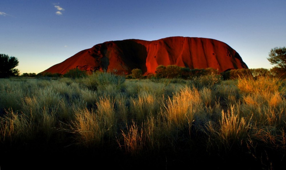 the-sun-sets-on-ayers-rock-one-of-australias-major-tourist-destinations-attracting-400000-visitors-every-year.jpg